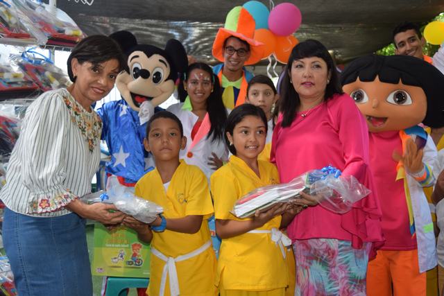 Nohoya Cardona y Amparo Ortiz entregando el recurso educativo a los niños.